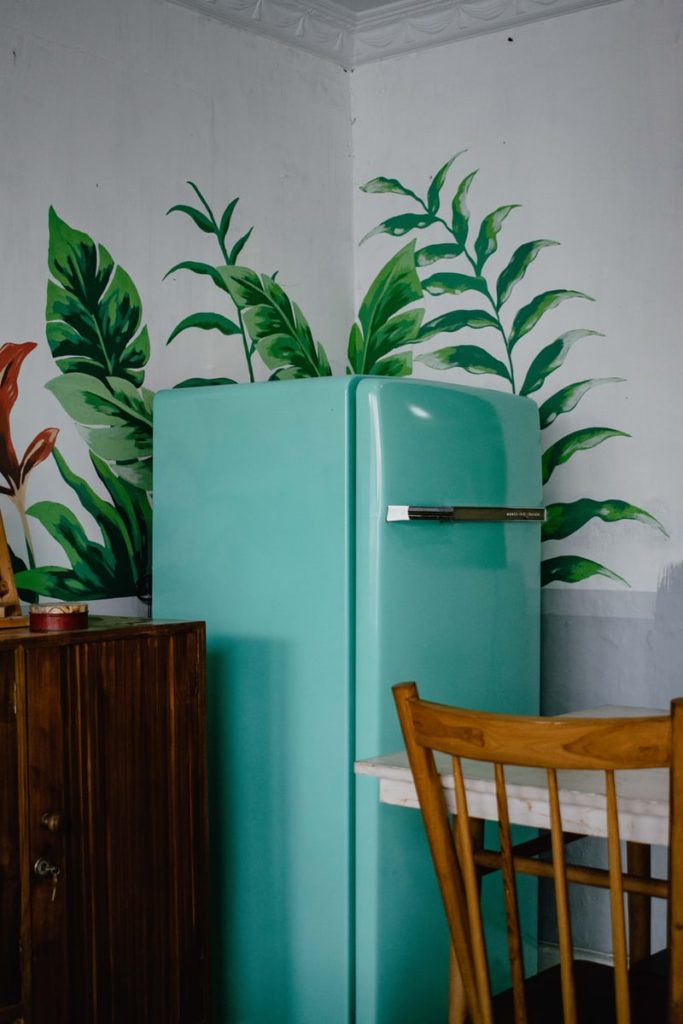 a green refrigerator in the kitchen