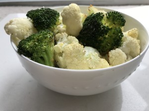 garlic parmesan broccoli and cauliflower in a bowl.