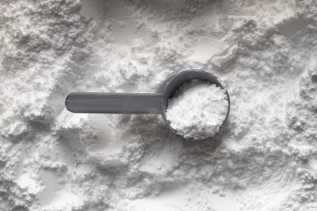 creatine powder with a scoop