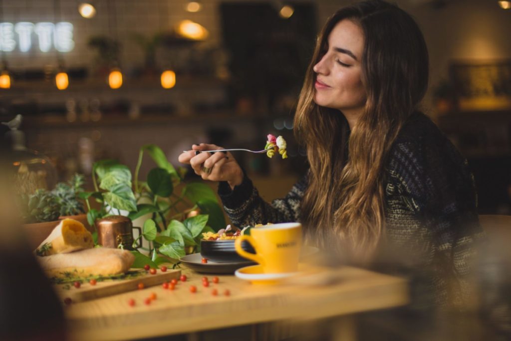 woman adopting 7 healthy eating habits at table
