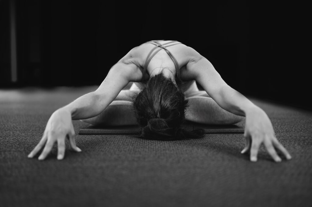 woman stretching during post WOD recovery on floor