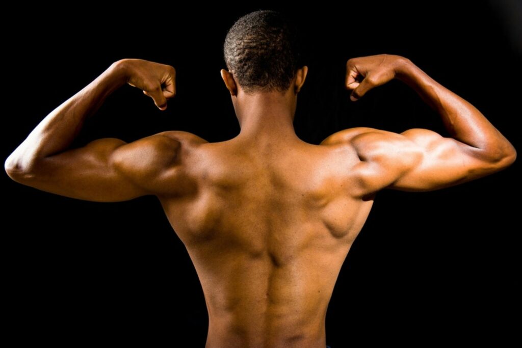 rear view of a man flexing with his shirt off